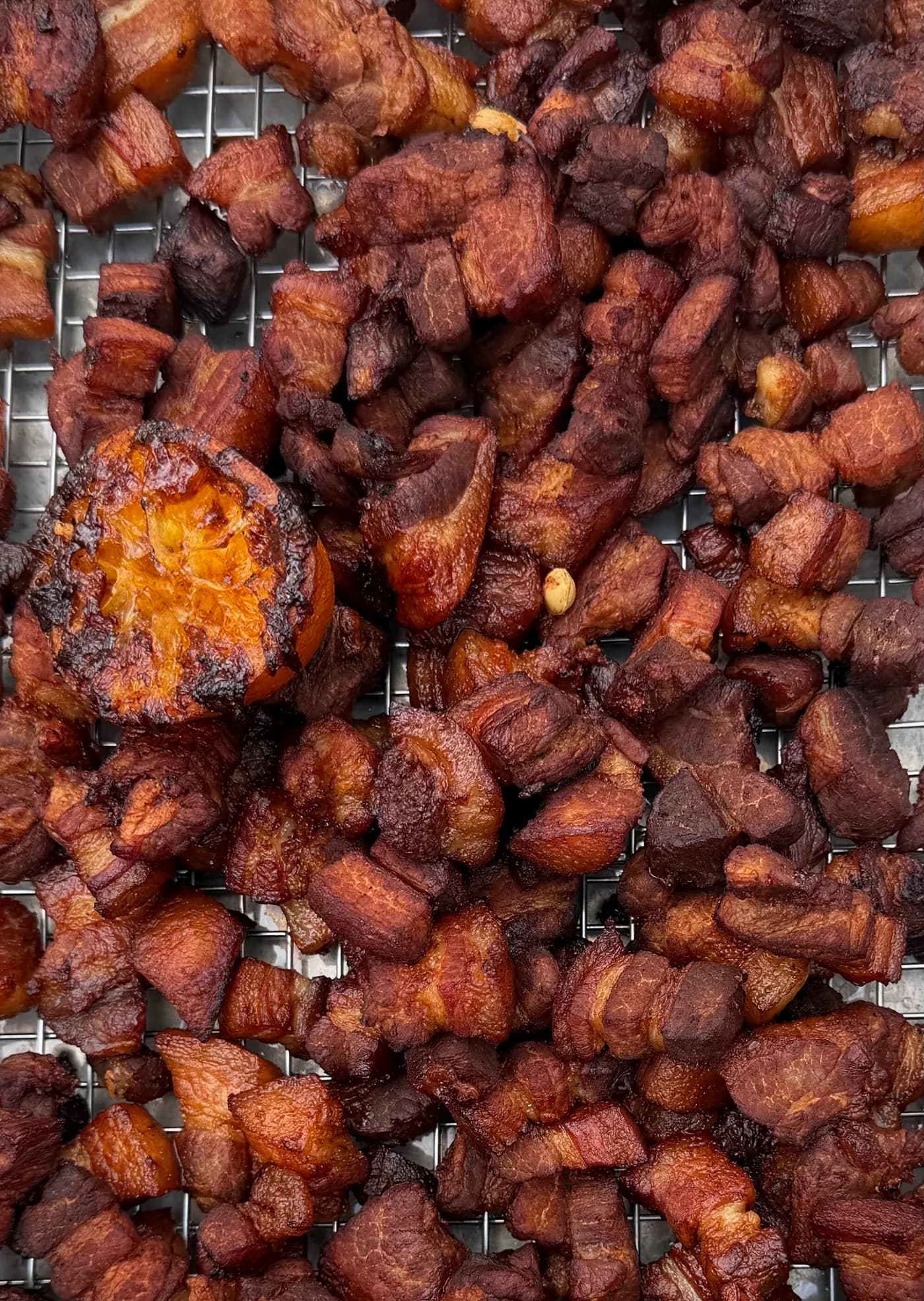 Crispy fried pork belly pieces on a cooling rack